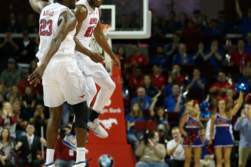 Southern Methodist's Akoy Agau (23) and Ben Emelogu II (21) celebrate after they took the...