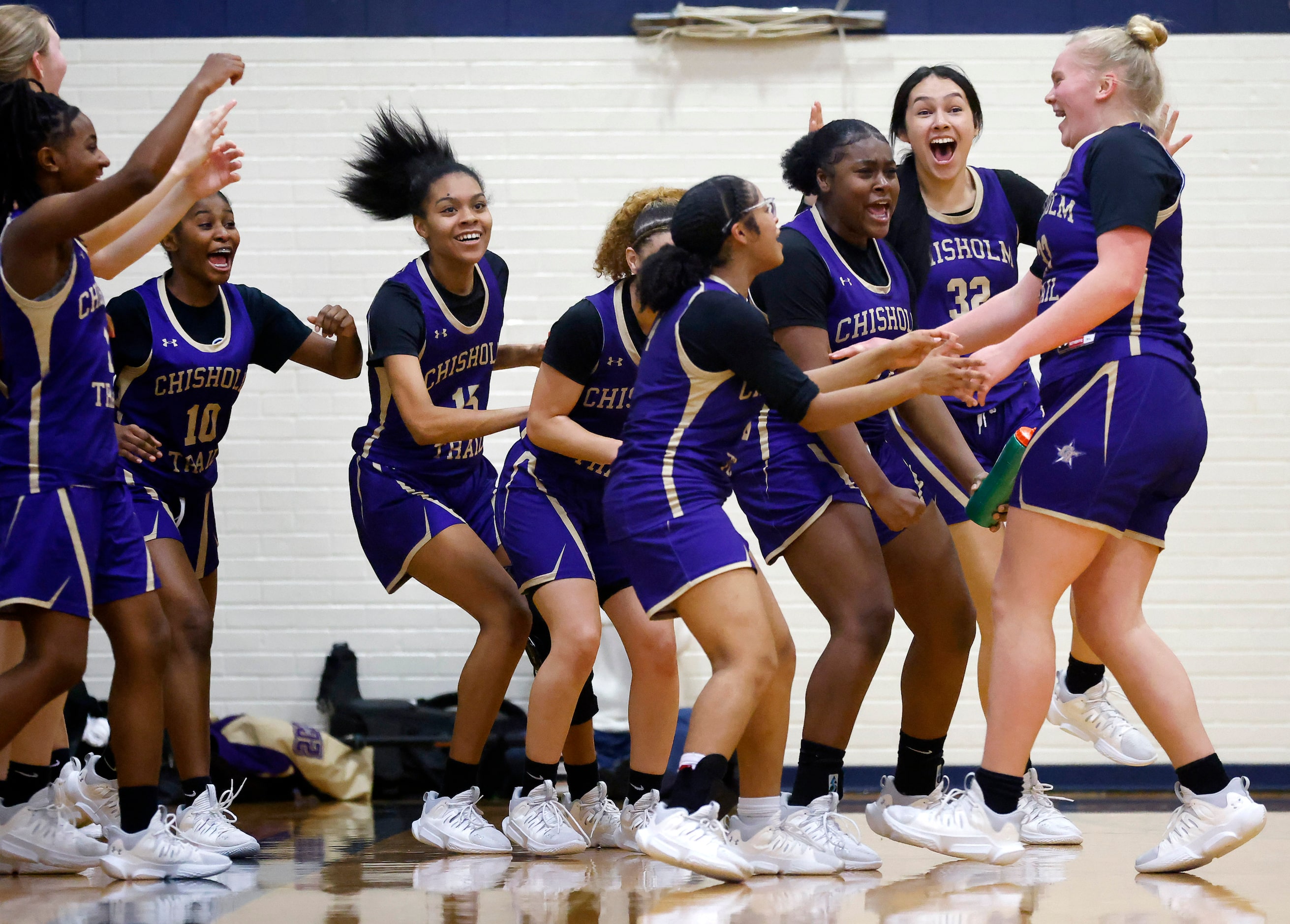 Saginaw Chisholm Trail’s Mikayla Mercer (right) is congratulated by teammates after scoring...