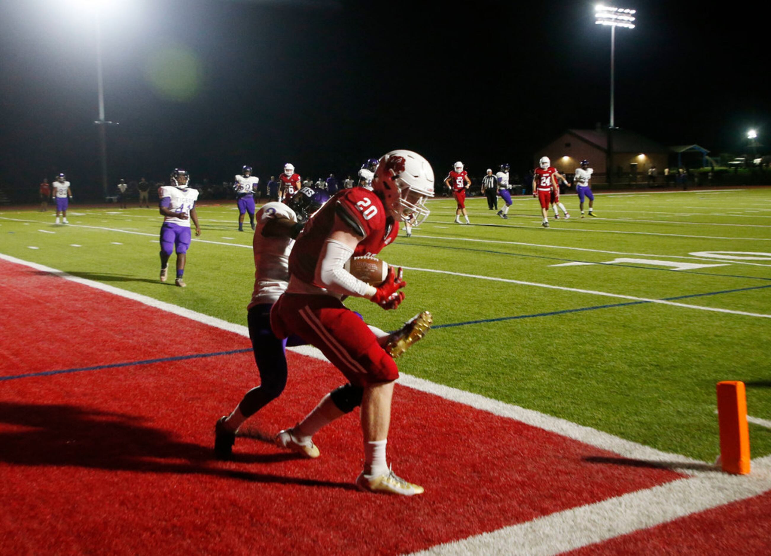 Grapevine Faith Christian's Hilton Harris (20) scores a touchdown in front of Lincoln's...
