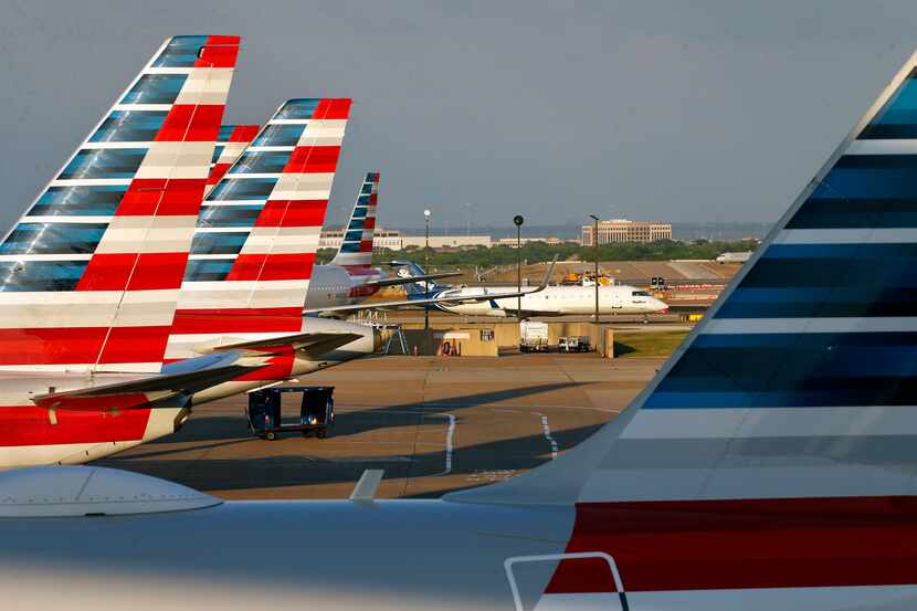 American Airlines jets are parked at Terminal C as a Skywest jet taxis to the gate at...