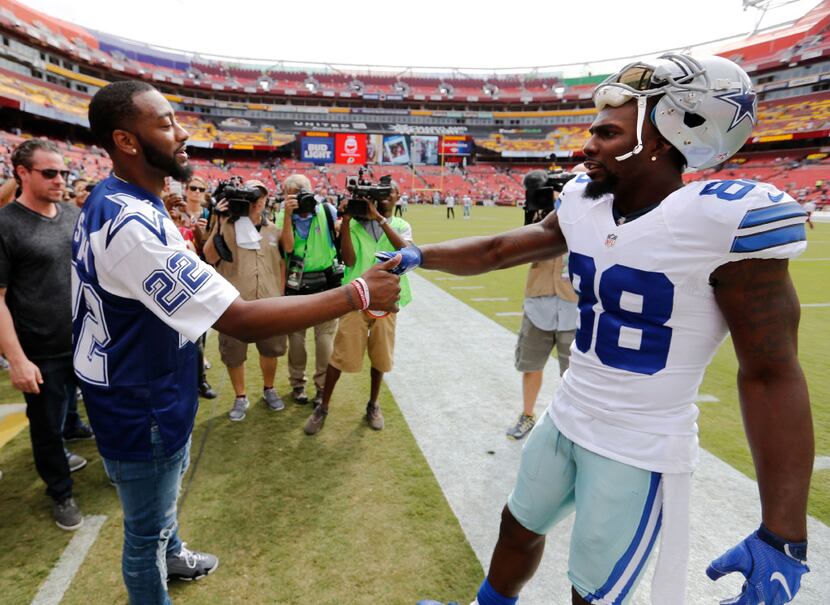 Dallas Cowboys wide receiver Dez Bryant (88) greets Washington Wizards John Wall before a...