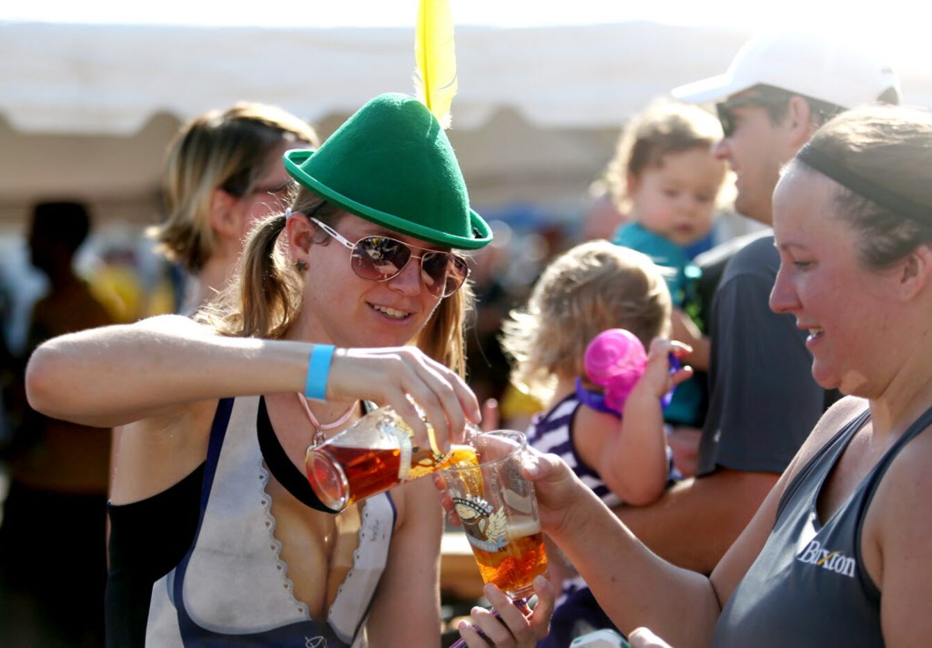 Nadine Grosse, cq, shares some of her beer with friend Diana Dirks, cq, at the Rahr...