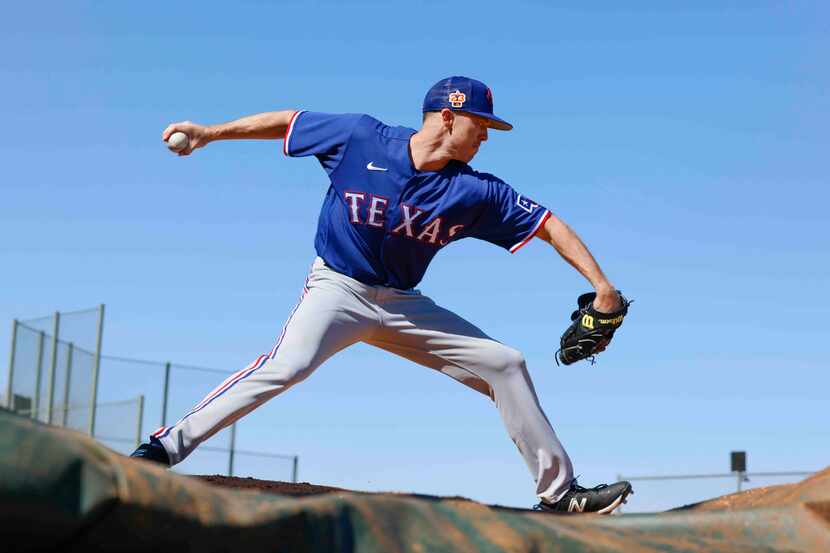 Texas Rangers right handed pitcher Chase Lee practices pitching during a spring training...