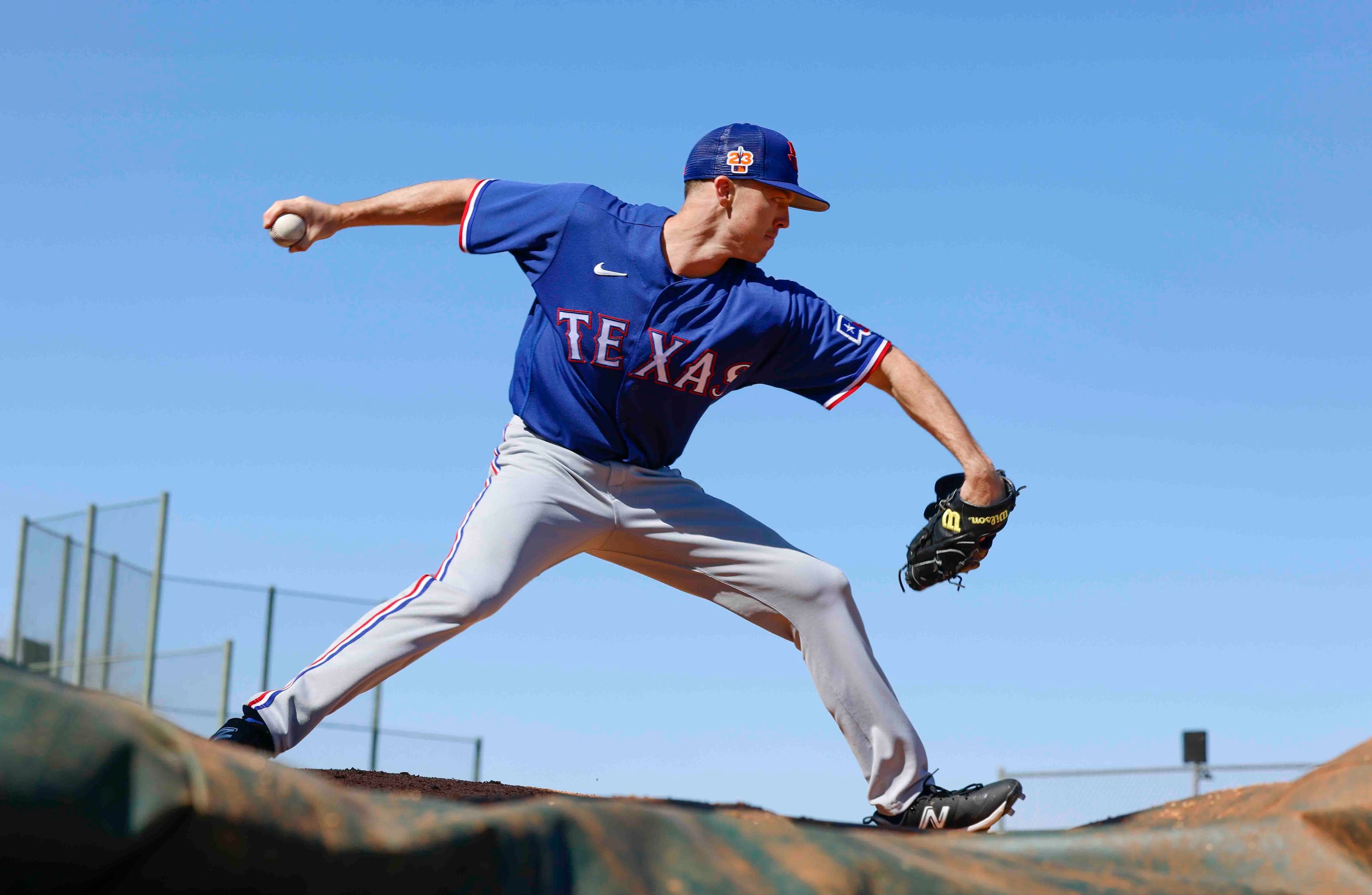 Texas Rangers right handed pitcher Chase Lee practices pitching during a spring training...