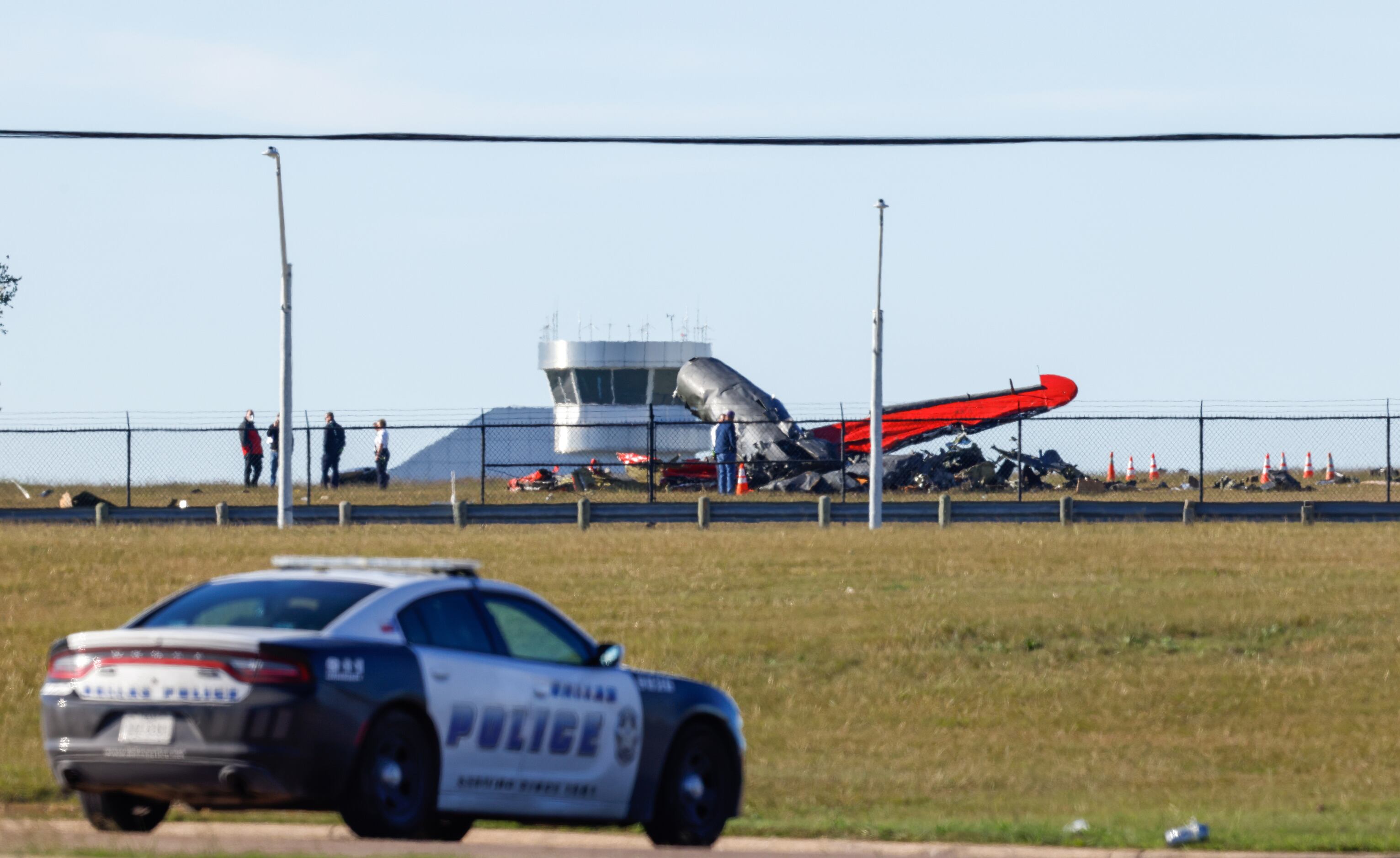 Police respond to a mid-air collision between two planes within the fence line of the Dallas...