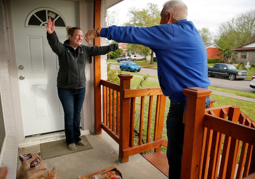 Former coach and local sportscaster Eddy Clinton of Plano (right) gives Kristin Tarrence a...