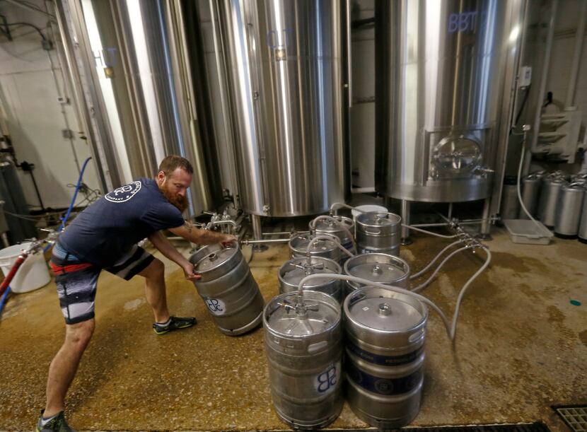 Brewer Rich Franzen moves one of the kegs being filled with beer at Peticolas Brewing Co. No...