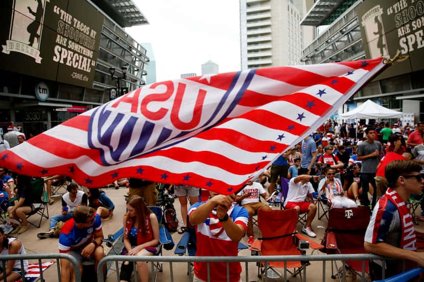 Carlos Velasquez, of Dallas, waves a United States National Soccer Team flag before a watch...