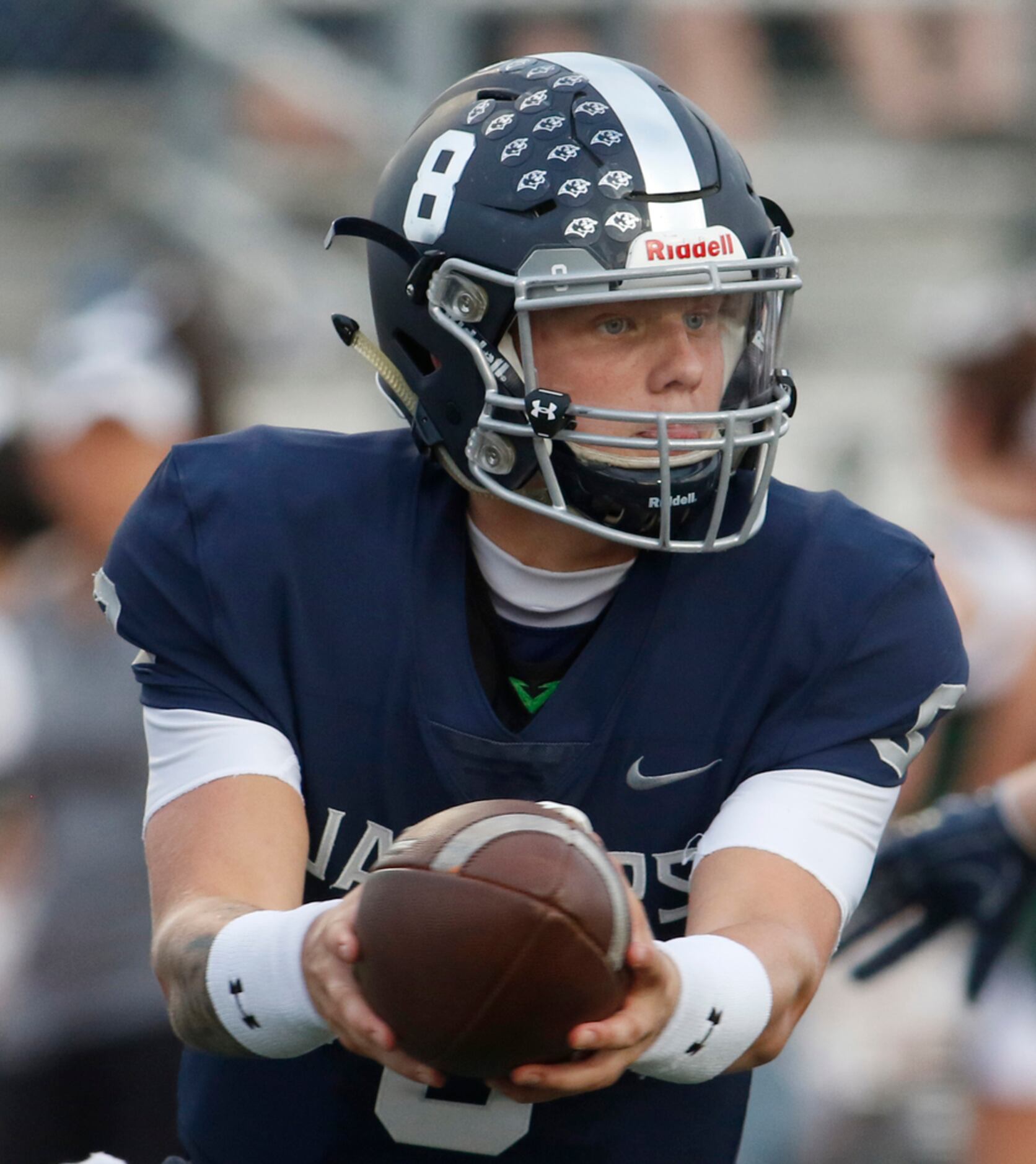 Flower Mound quarterback Blake Short (8) spins to hand off to one of his running backs...