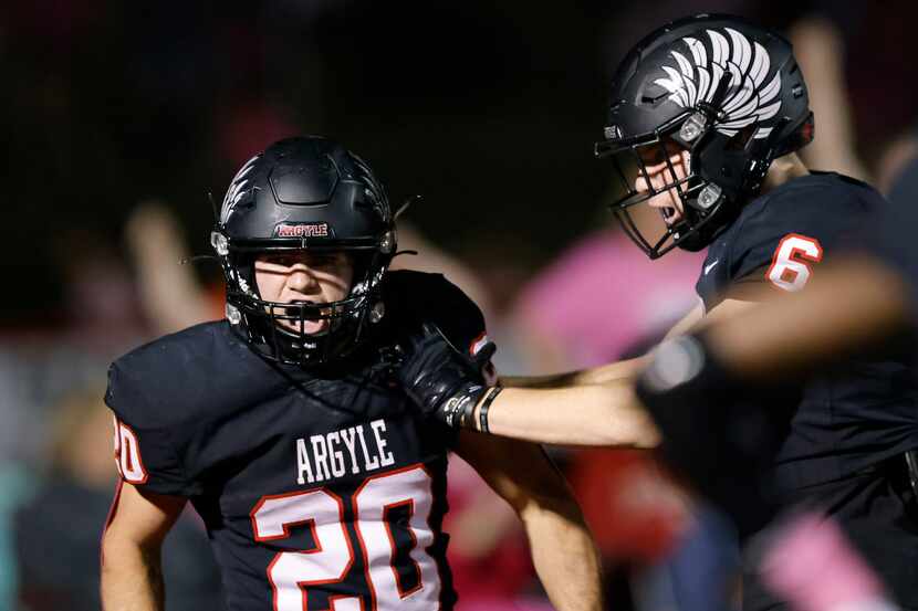 Argyle’s Landon Farris (20) and Lane Stewart (6) are fired up as they come up with a big...
