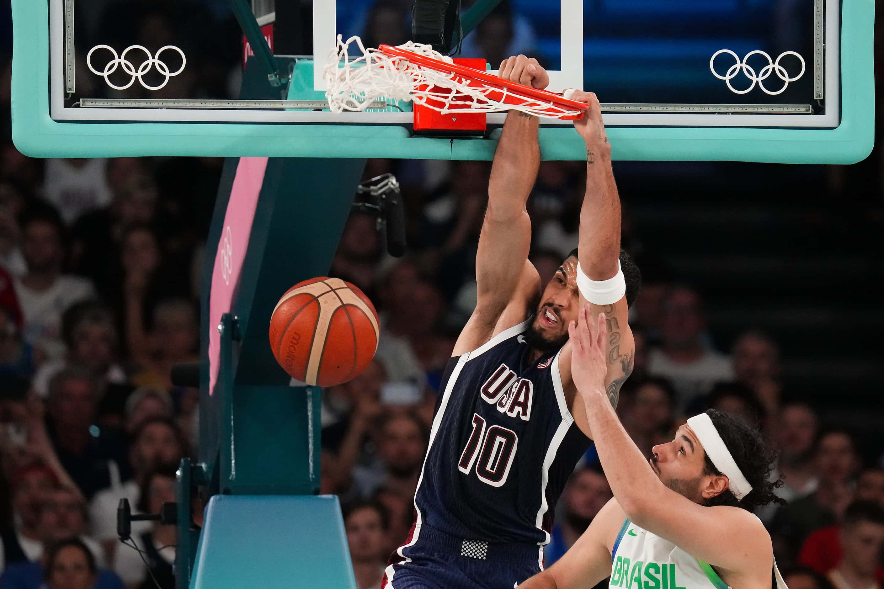 Jayson Tatum (10) of the United States dunks over Leo Meindl of Brazil during a men’s...