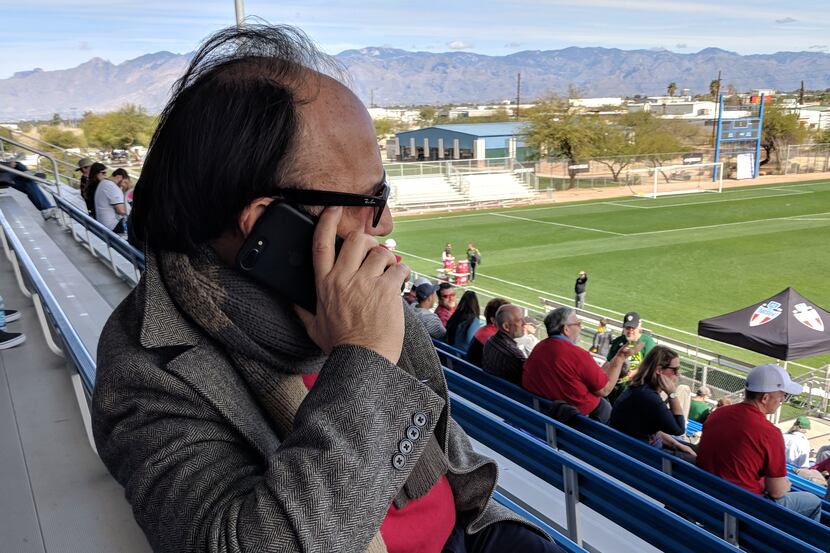 Fernando Clavijo works the phone during FC Dallas spring training in Arizona. (2-17-18)