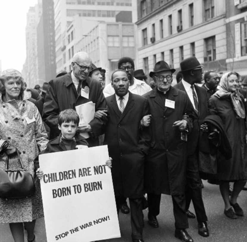 Civil rights leader Rev. Martin Luther King, Jr., (C) is accompanied by famed pediatrician...