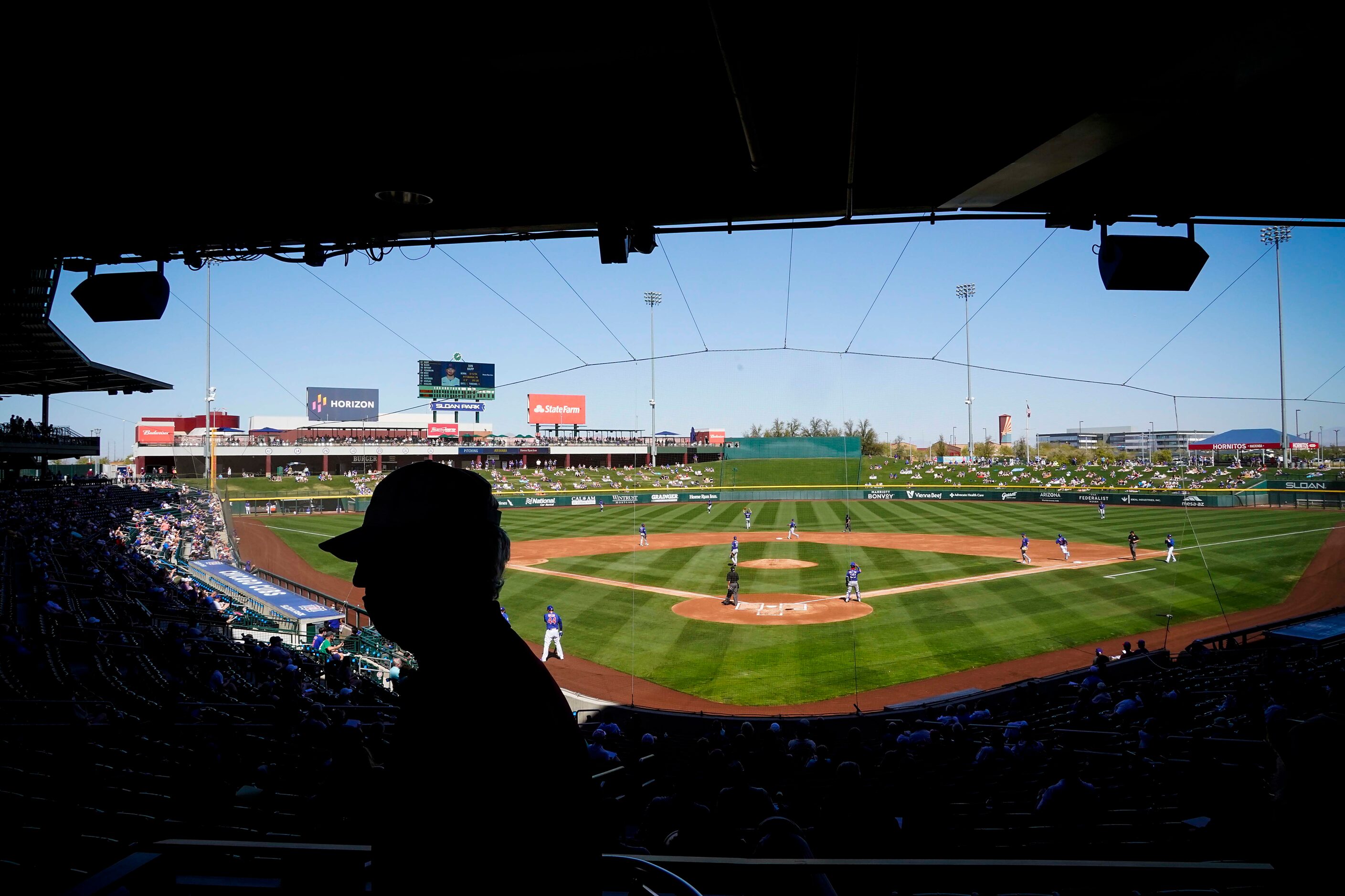 Fans watch a spring training game between the Texas Rangers and the Chicago Cubs at Sloan...