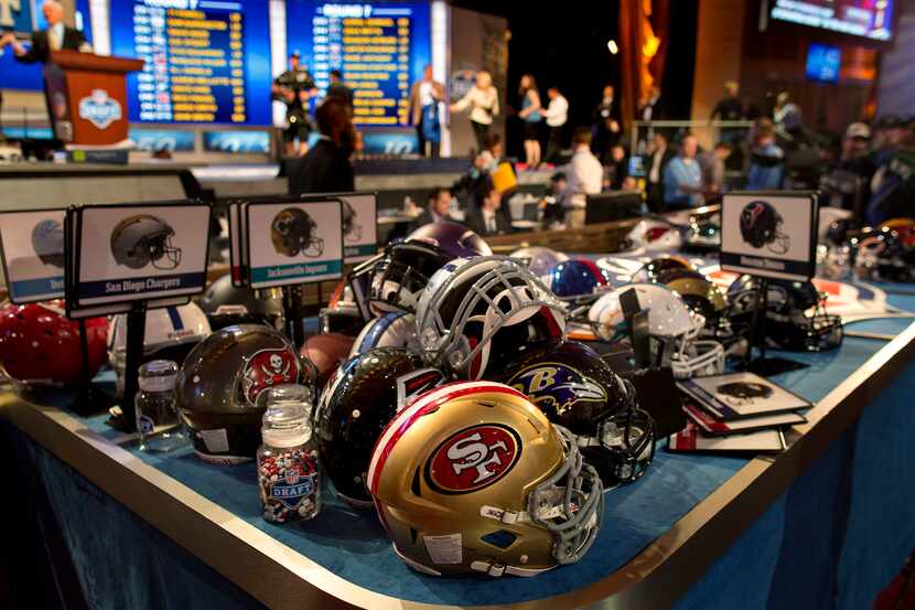 NFL helmets are stacked on a table at the conclusion of the 2013 NFL Draft at Radio City...