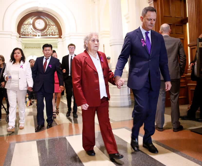 Rep. Rafael Anchia, D-Dallas (right) escorts Amparo Camacho, grandmother of 12-year-old...