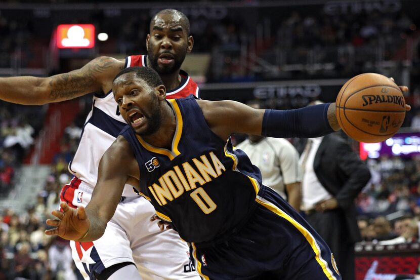 WASHINGTON, DC - DECEMBER 28: C.J. Miles #0 of the Indiana Pacers dribbles past Marcus...