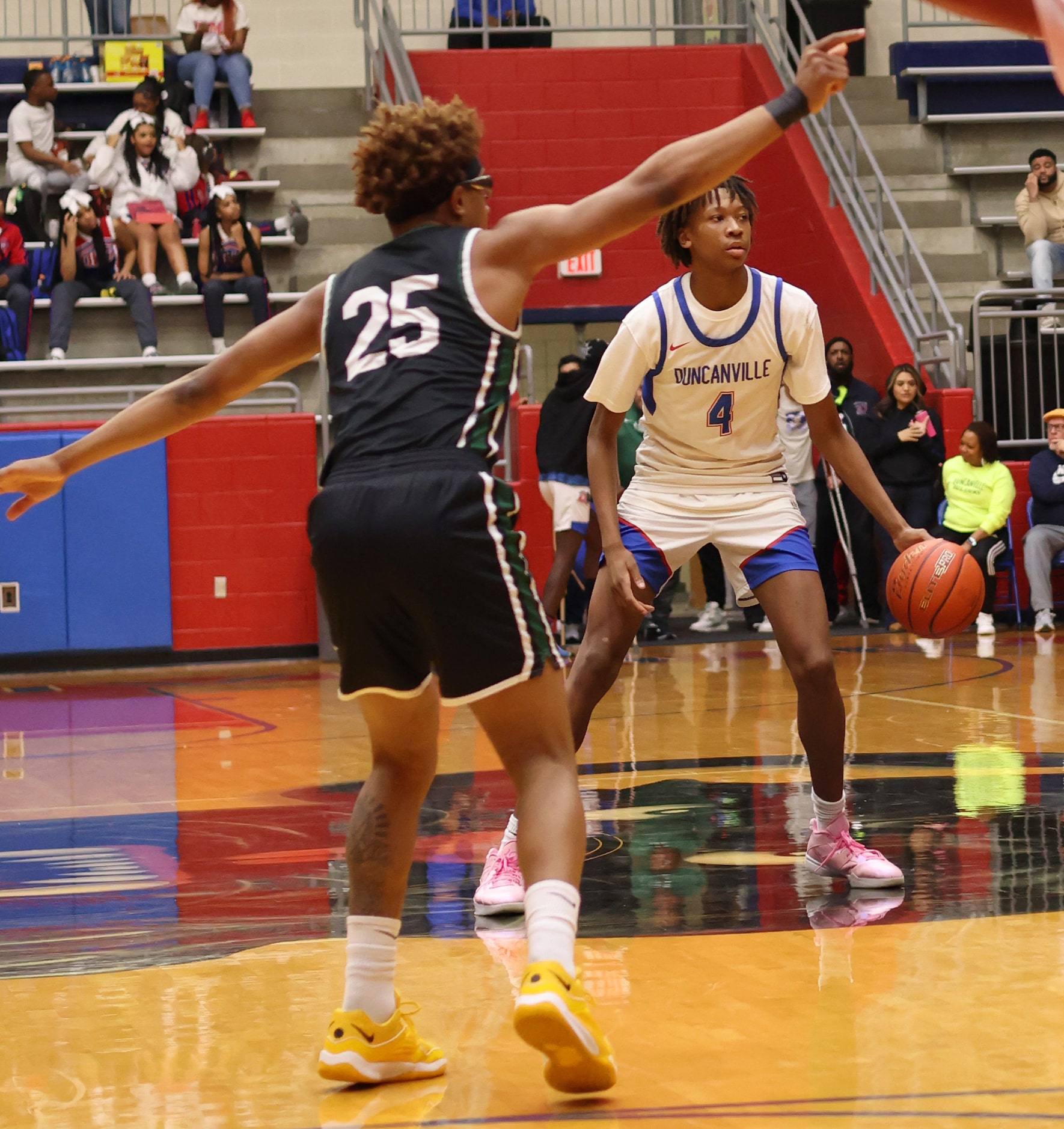 Duncanville's Cameron Smith (4) looks to pass as DeSoto's Shelton Manning Jr. (25) defends...