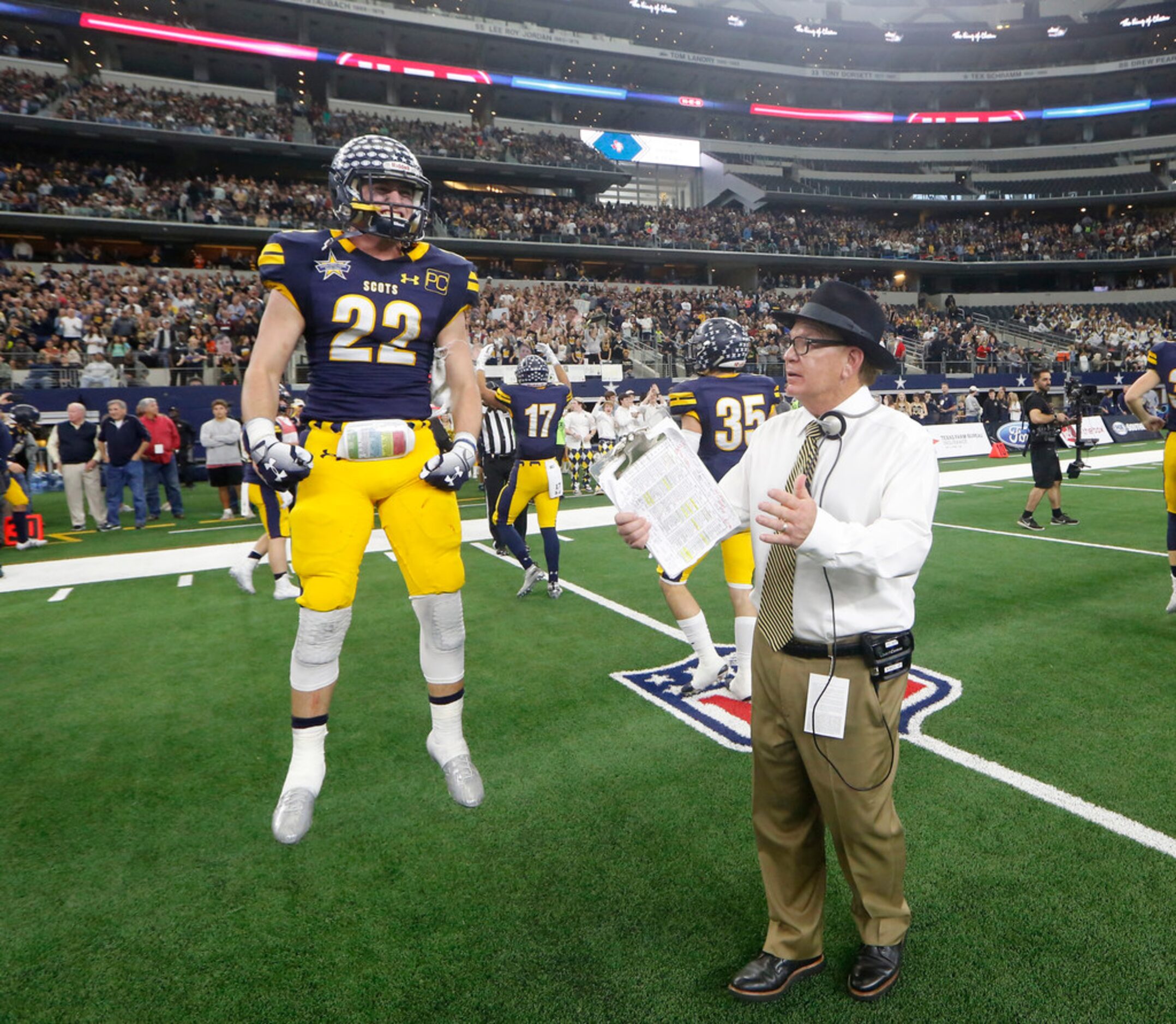 Highland Park's Benner Page (22) jumps for joy next to head coach Randy Allen after beating...