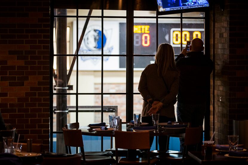 Fans watch from above in the Old No. 7 club as Dallas Mavericks forward Dirk Nowitzki warms...