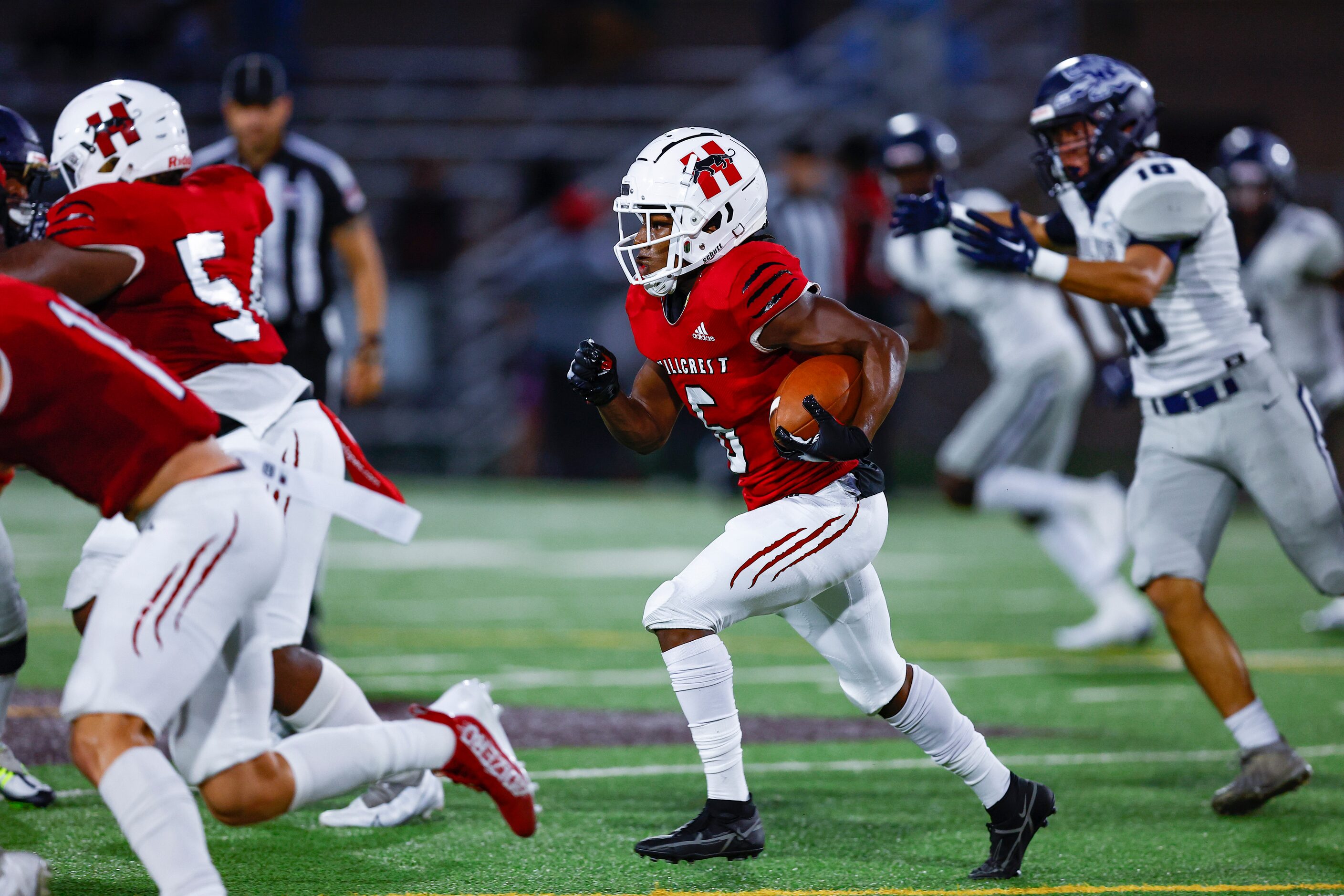 Hillcrest senior running back Jaden Hodge (6) looks for room against the Carrollton...