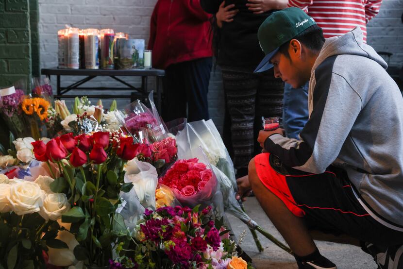 Flowers are placed at a vigil on Tuesday, March 14, 2023, at the Northwest Dallas apartment...