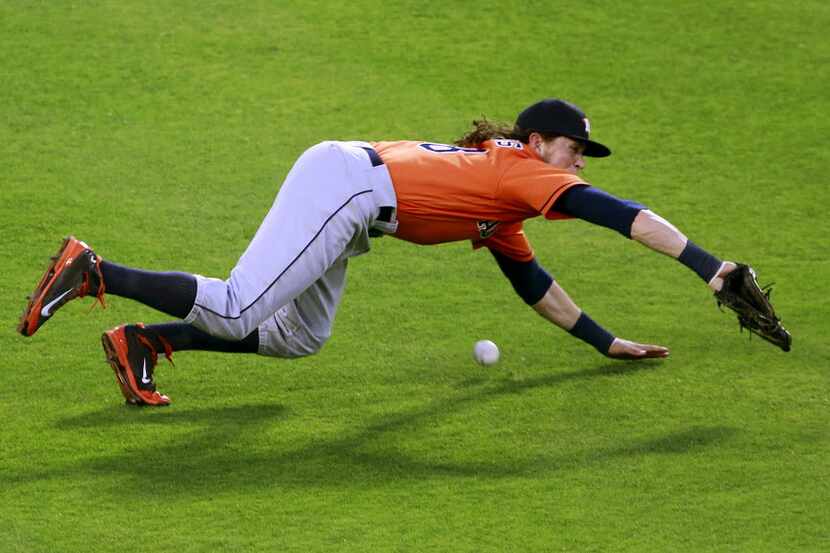 Houston Astros left fielder Colby Rasmus (28) misses a diving catch on a ball hit by Texas...