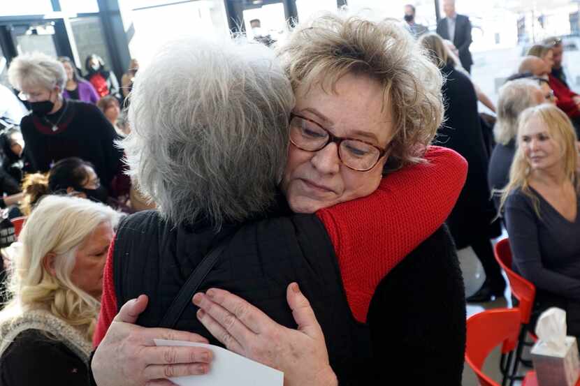Debra Blubaugh hugs a family friend during a ceremony celebrating the passing of Senate Bill...
