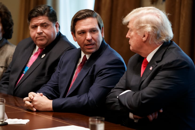FILE - Gov.-elect Ron DeSantis, R-Fla., talks with President Donald Trump during a meeting...