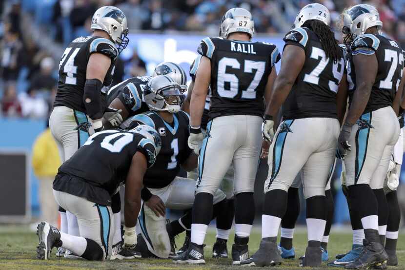 Carolina Panthers' Cam Newton (1) calls a play in the huddle against the Washington Redskins...