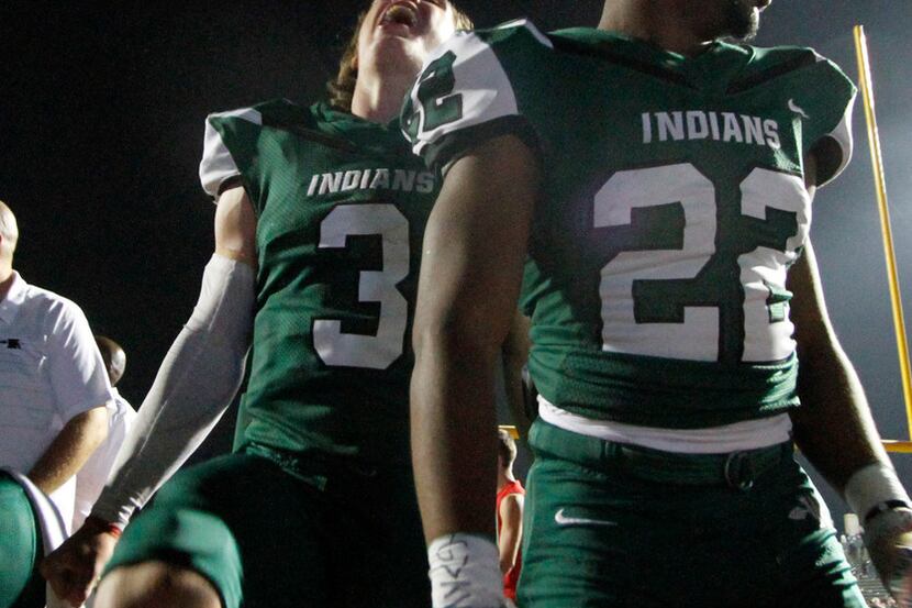 Waxahachie quarterback Bryse Salik (3) lets out a yell as he is pictured with teammate Eric...