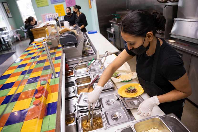 Leticia Galindo prepares a taco at Milagro Tacos Cantina on Wednesday, Jan. 19, 2022, in...