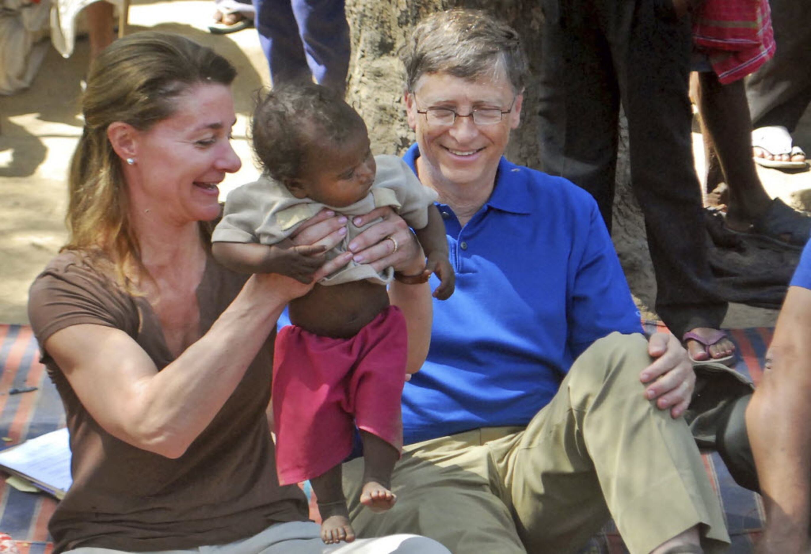 Melinda Gates and her husband, Microsoft founder Bill Gates, play with a child in Jamsot...