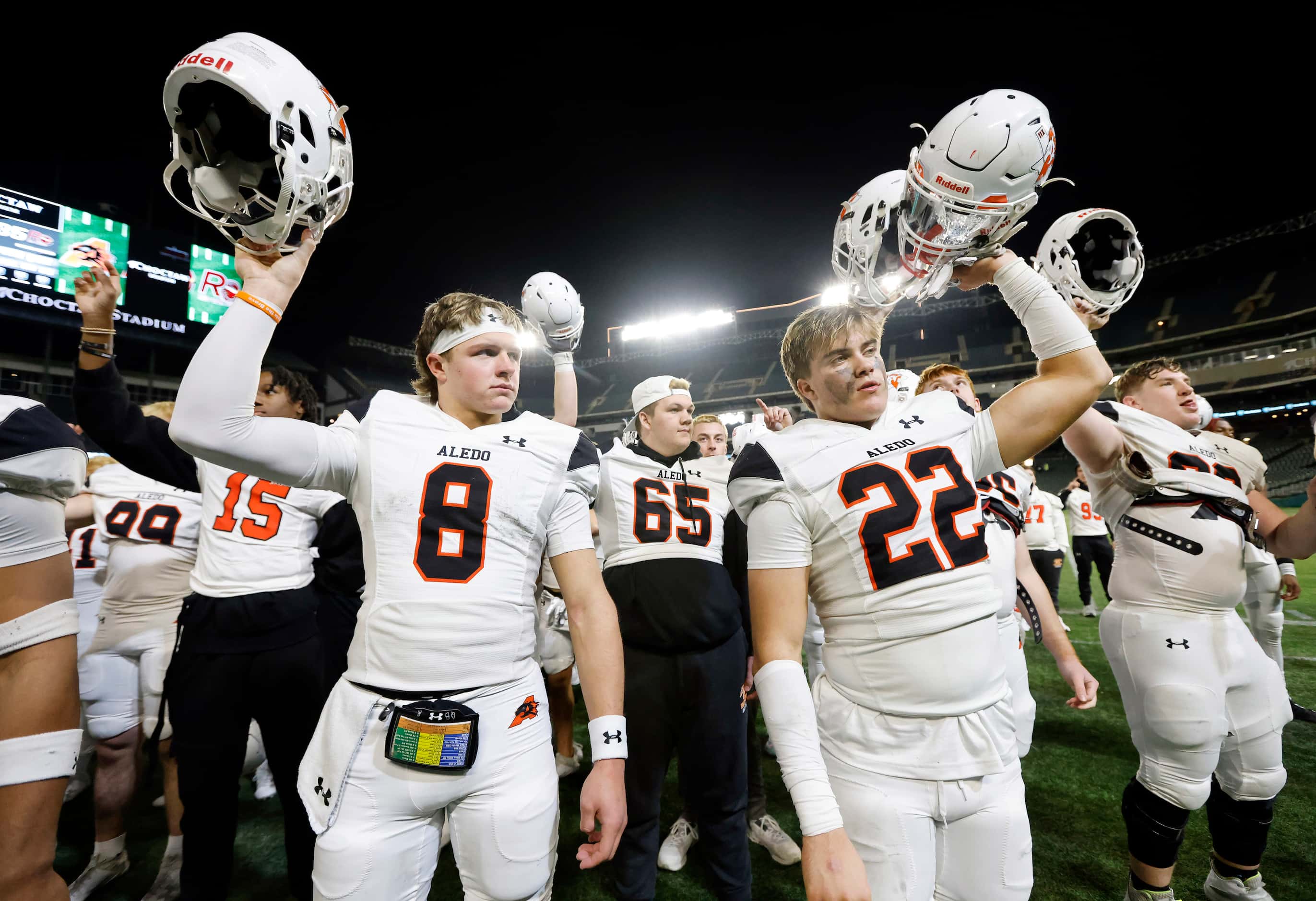Aledo quarterback Hauss Hejny (8) and linebacker Ben McElree (22) join the band in the...