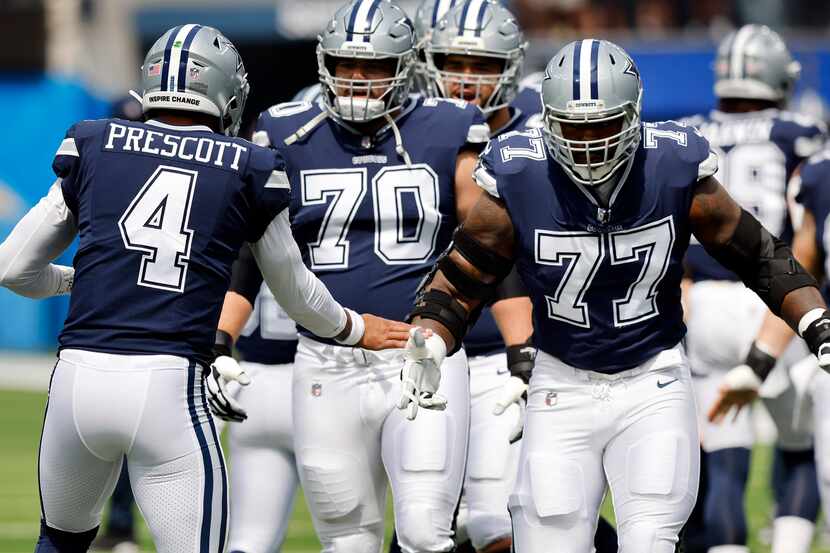 Dallas Cowboys quarterback Dak Prescott (4) greets his guard Zack Martin (70) and offensive...