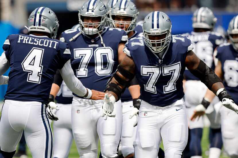 Dallas Cowboys quarterback Dak Prescott (4) greets his guard Zack Martin (70) and offensive...