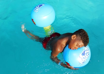 King Horton, 10, of Dallas, takes a moment to rest on an inflatable at the Bonnie View...