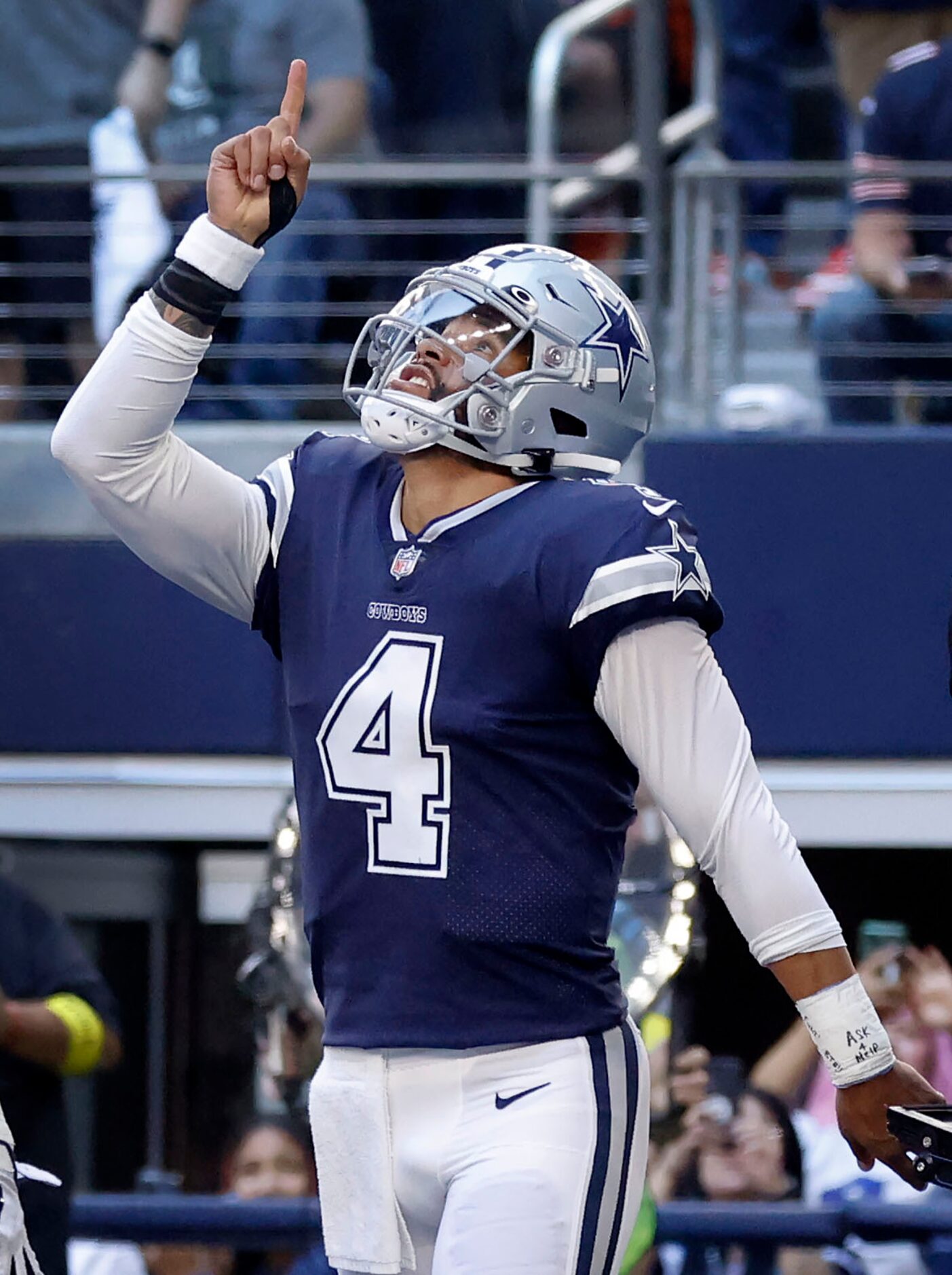 Dallas Cowboys quarterback Dak Prescott (4) points skyward after running in a first quarter...