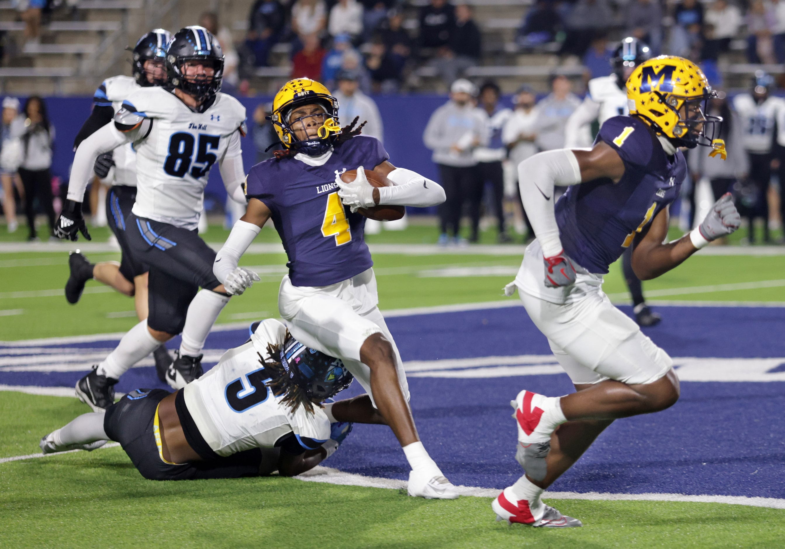 McKinney player #4 Ja'bree Bickham breaks a tackle attempt by Rock Hill player #5 Armaree...