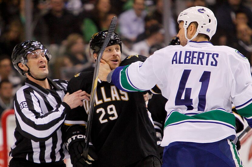 Dallas Stars center Steve Ott (29) and Vancouver Canucks defenseman Andrew Alberts (41)...