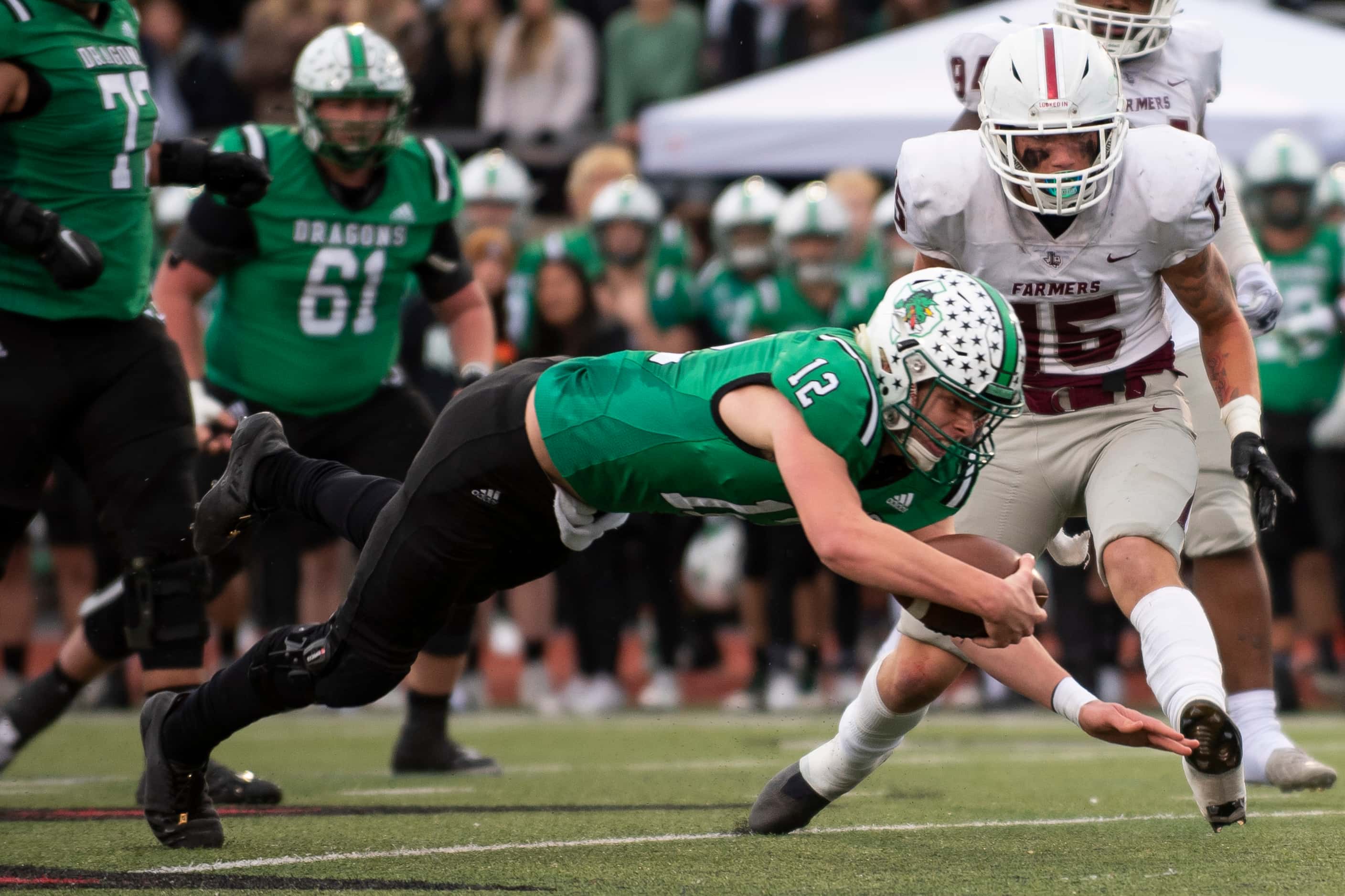 Southlake Carroll junior Kaden Anderson (12) leaps forward to get a first down during the...