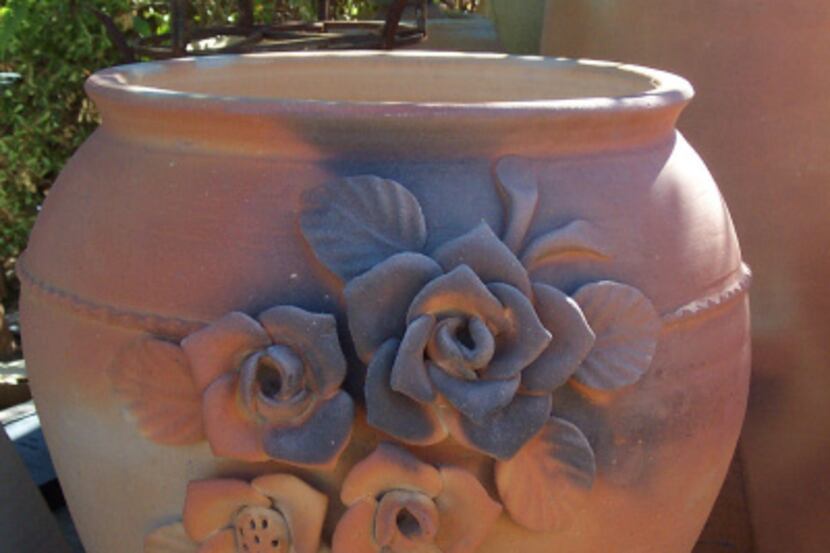 Hand-applied roses on a large hard-fired, terra-cotta urn.