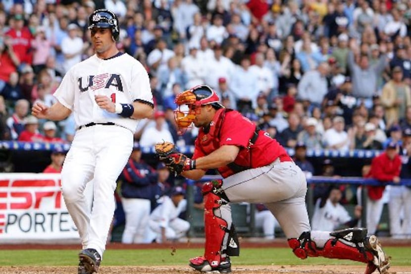 ORG XMIT: *S0415771808* PHOENIX - MARCH 08:  Michael Young #1 of Team USA scores past...