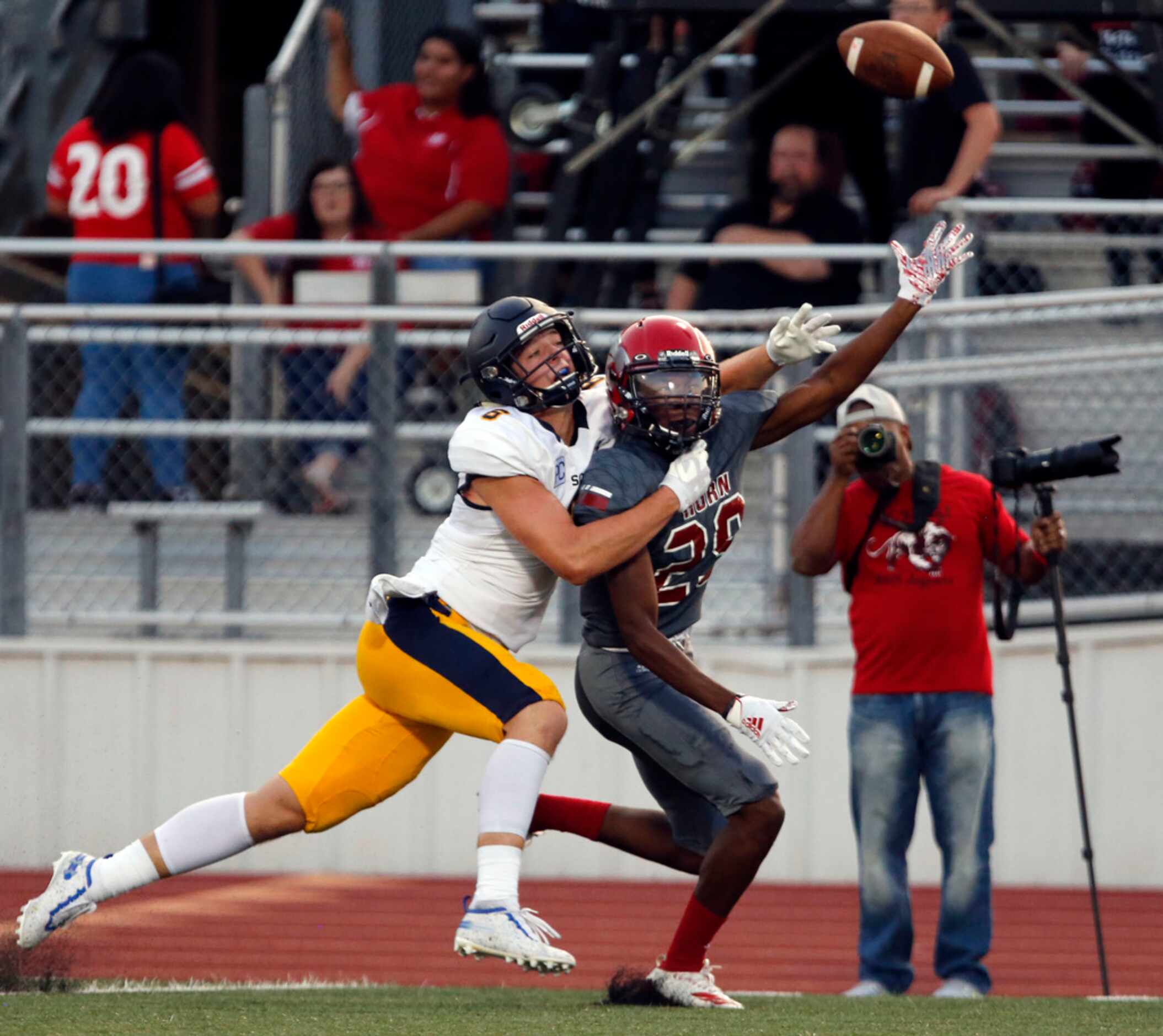 A pass sails over the head of John Horn's Andrew Gaines (29), as Highland Park's Paxton...