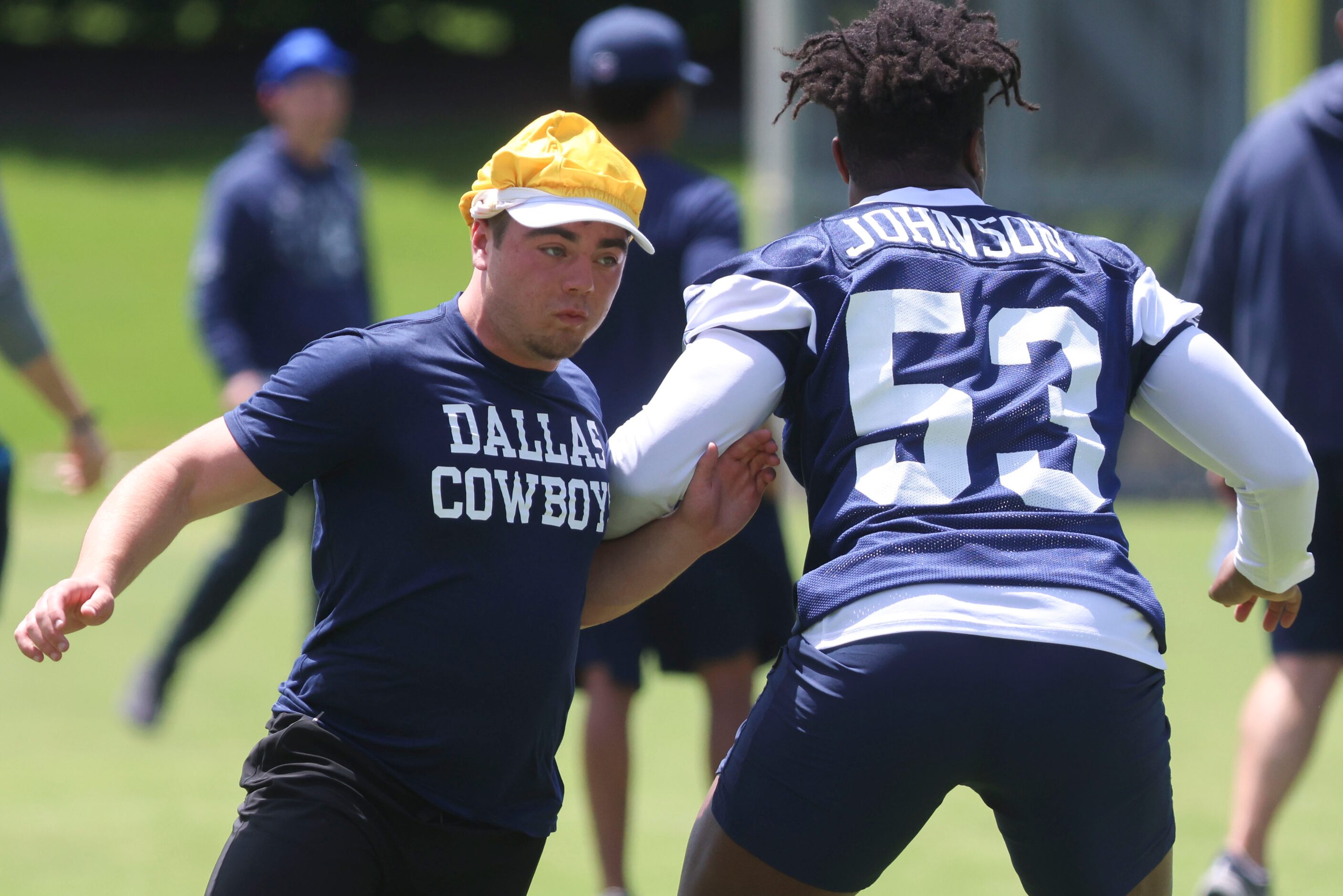 Son of Dallas Cowboys defensive run game coordinator Paul Guenther take part in helping his...