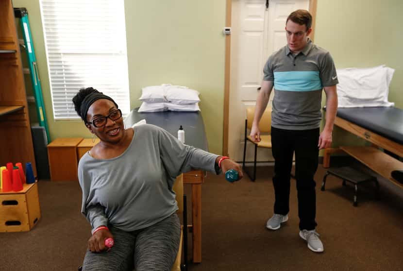 Samantha Barber lifts weights in a session with physical therapist Blake Withrow at Green...