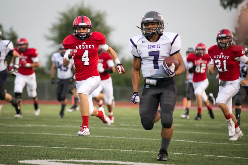 Aubrey's wide receiver, Cameron Moore (4), sophomore, runs down Anna's running back, Isaac...