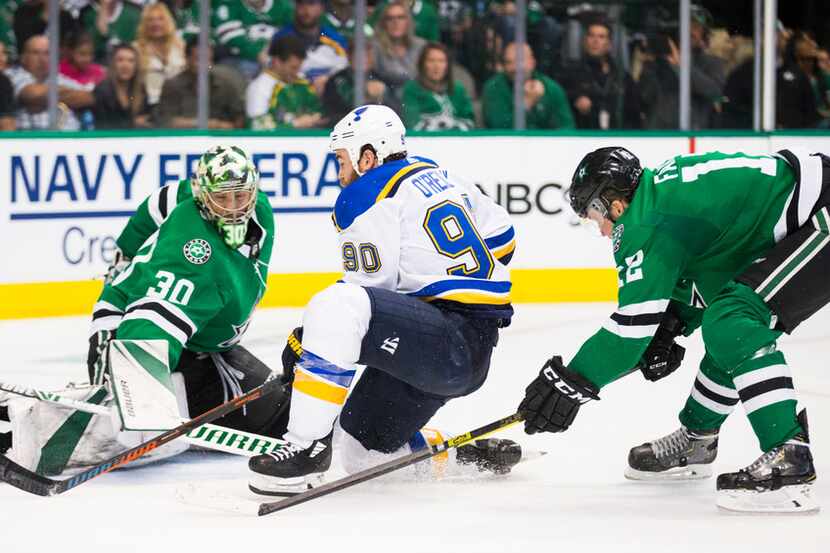 Stars goalie Ben Bishop defends as Dallas Stars center Radek Faksa (12) pursues St. Louis...