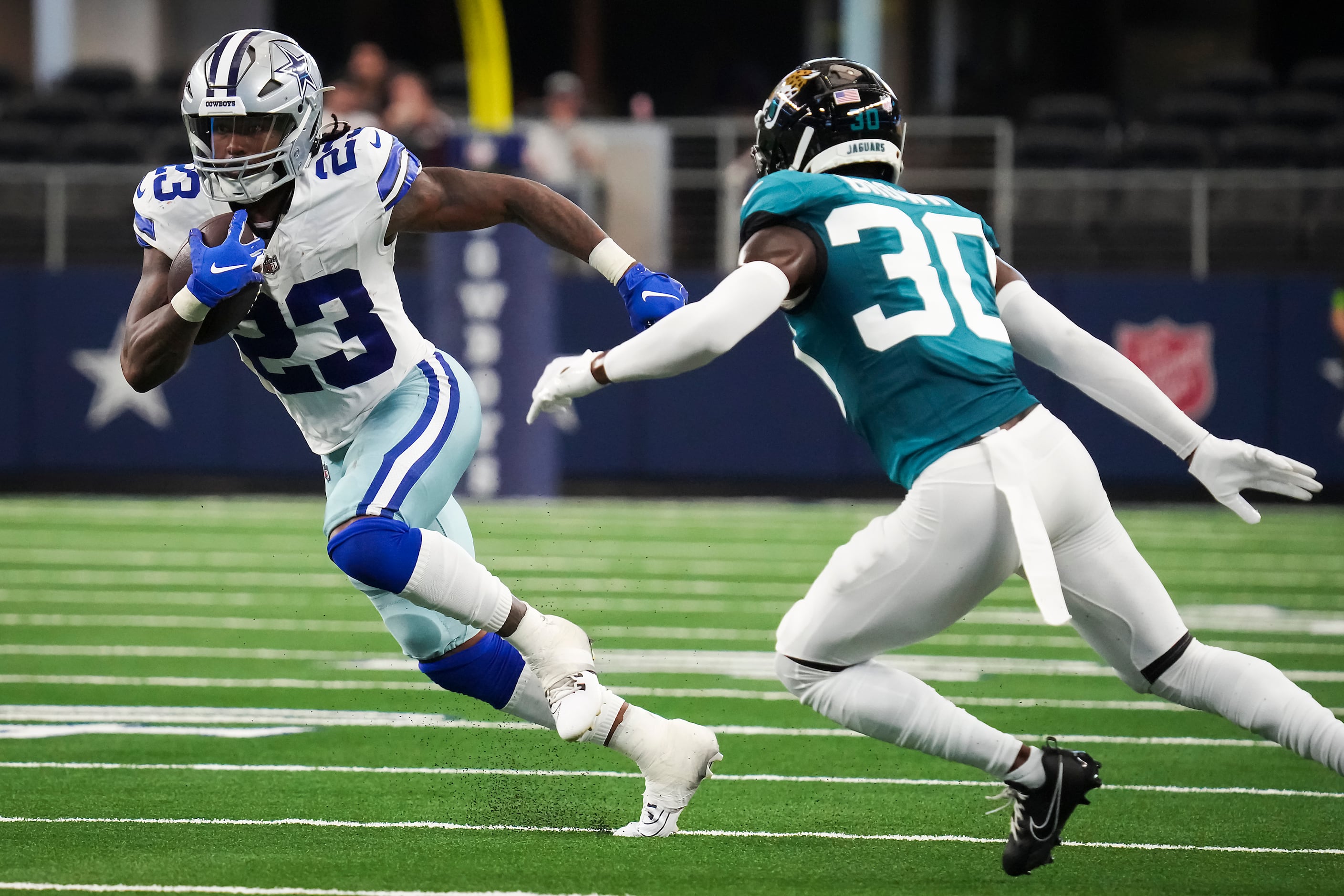 Dallas Cowboys running back Rico Dowdle (23) runs the ball during the first  half of an NFL preseason football game against the Jacksonville Jaguars,  Saturday, Aug. 12, 2023, in Arlington, Texas. Later