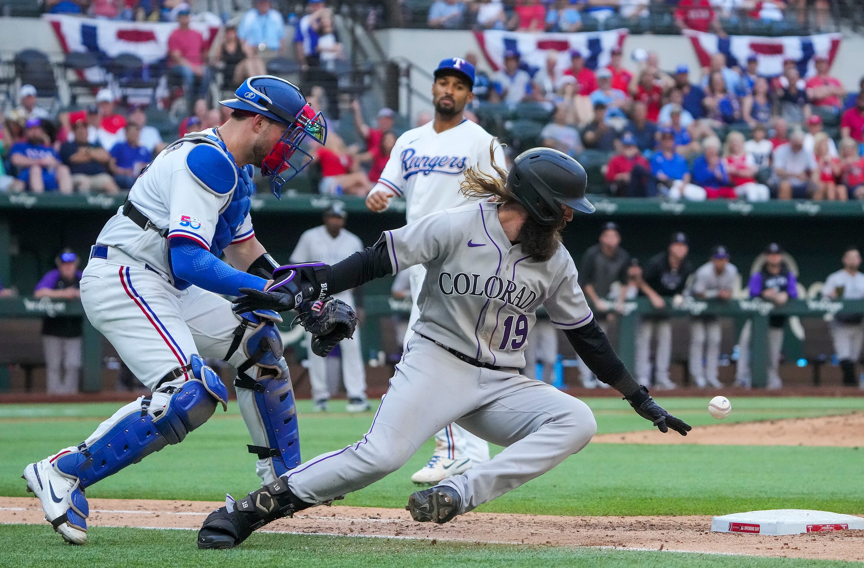 Colorado Rockies right fielder Charlie Blackmon dives for the bag as he is caught in a...